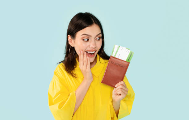 istock Amazed hispanic young woman hold fly ticket and passport 2000619968