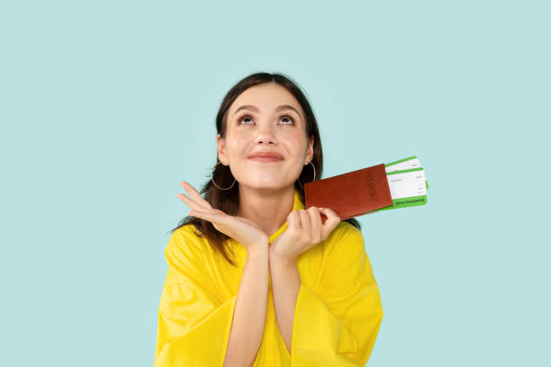 istock Cheerful Young Lady Holding Passport With Tickets 2000620039