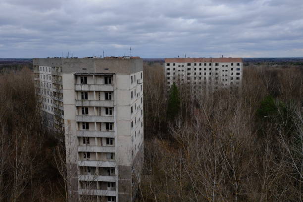 istock Abandoned panel houses among leafless trees in Pripyat. Beautiful cloudy sky over the city. Post-Soviet architecture. 2000622765