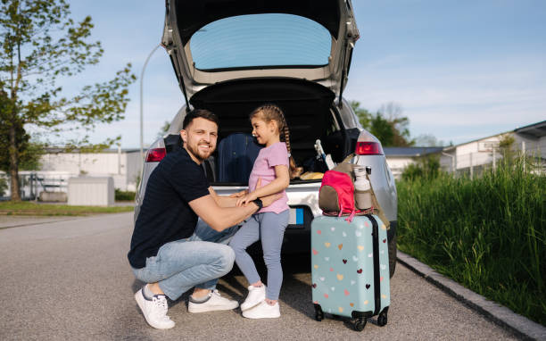Father help daughter loading to the trunk with luggage before traveling while mom packs her luggage. High quality photo