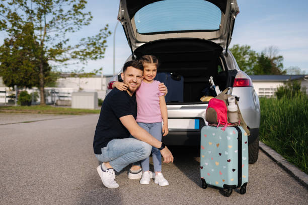 istock Father help daughter loading to the trunk with luggage before traveling while mom packs her luggage 2000643363