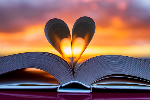 Umbria, Italy: Heart silhouette with an open book at sunset