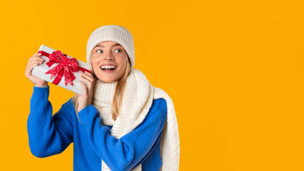 istock Happy woman holding a gift box with joy 2000665171
