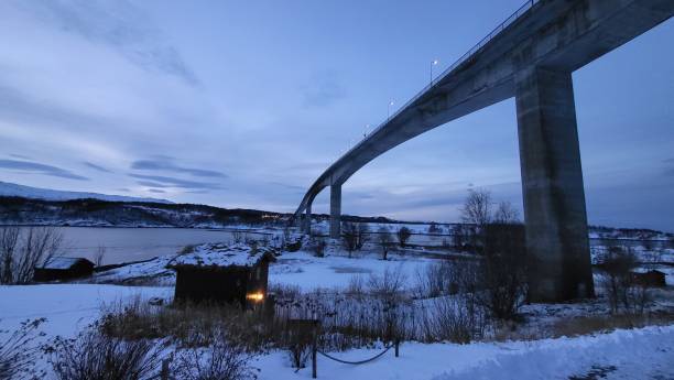 istock little red house and Saltstraumen Bridge 2000667436