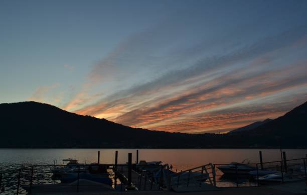 istock Red sunset sunbeams on the sky over the lake and mountains. 2000695969
