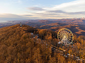 The Ferris wheel and observation tower with mountains in the background.