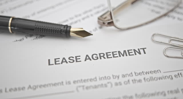 Business legal document concept : Pen and glasses on a lease agreement form. Lease agreement is a contract between a lessor and a lessee that allow lessee rights to use of a property owned by lessor