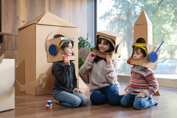 istock Children playing role play game as astronauts on mars 2000719516