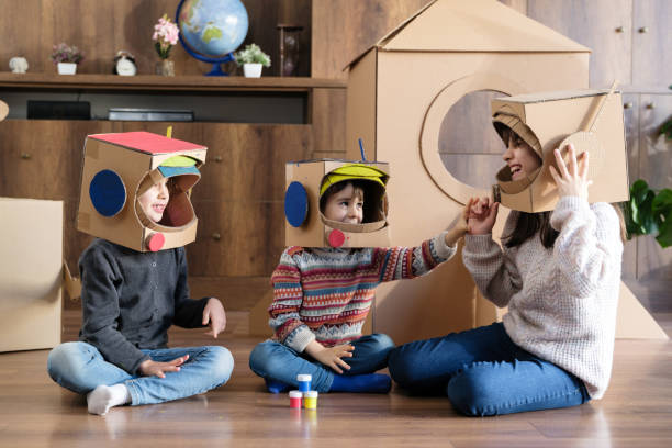 istock Children playing role play game as astronauts on mars 2000723786