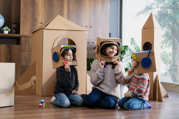 istock Children playing role play game as astronauts on mars 2000725403