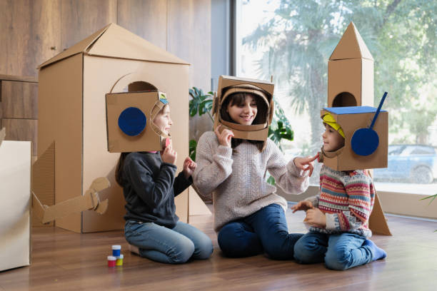 istock Children playing role play game as astronauts on mars 2000727393