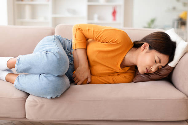 istock Young Asian Lady Suffering From Acute Abdominal Ache 2000748127