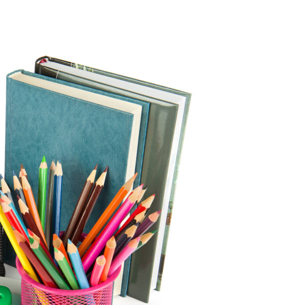 Set of colored pencils and books isolated on a white background. There is free space for text.