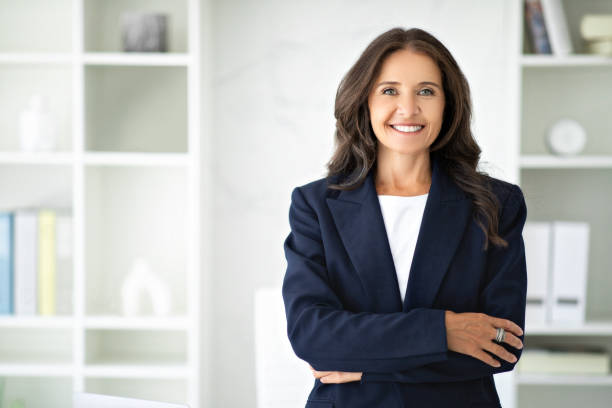 Confident mature woman posing in modern office