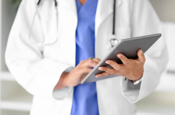 istock Cropped of lady doctor working on digital tablet 2000773944