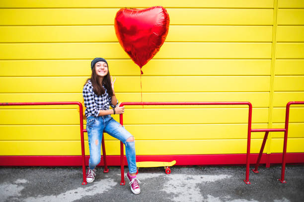 istock Happy girl with heart shape balloon 2000781960