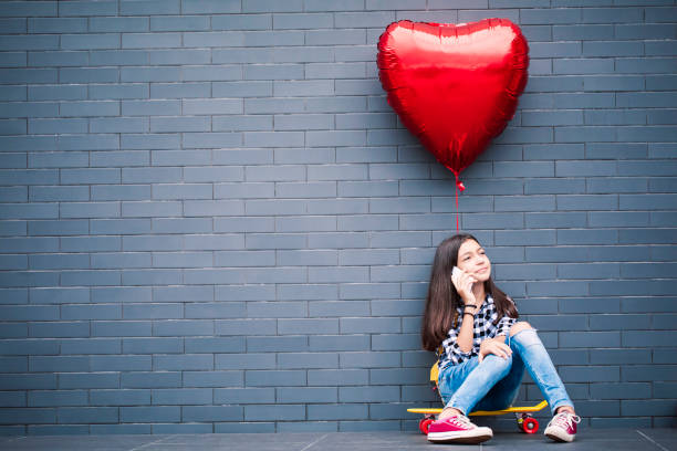 istock Girl with heart shape balloon 2000783035