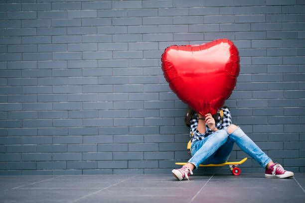 istock Girl with heart shape balloon 2000783608