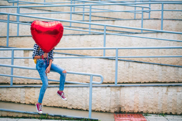 istock Girl with heart shape balloon 2000784168