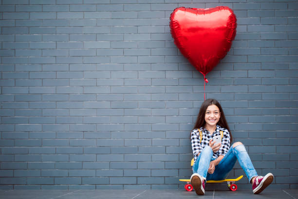 istock Girl with heart shape balloon 2000784726