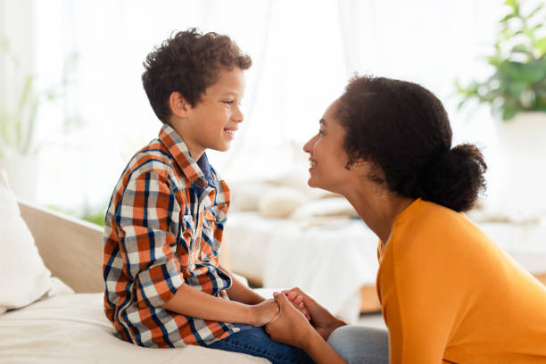 istock Joyful mother and son engaging in chat talking at home 2000804875