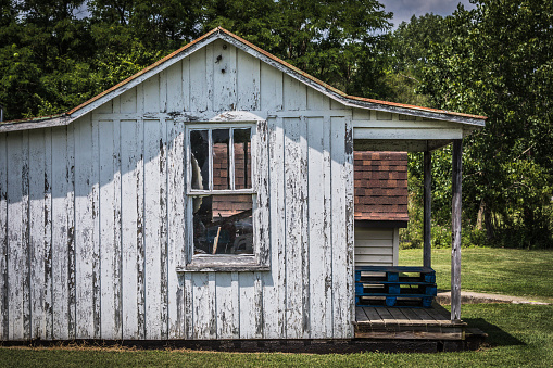 An old shed, weathered by time, stands silent with only one window. A common scene in rural America.