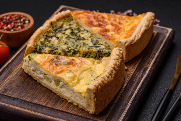 istock Delicious crispy quiche cut into slices with cheese, broccoli, tomatoes, salt, spices and herbs 2000860875