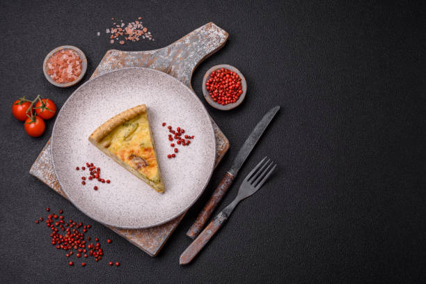 istock Delicious crispy quiche cut into slices with cheese, broccoli, tomatoes, salt, spices and herbs 2000861935