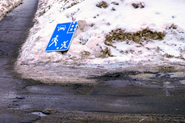 Road sign residential area broken and lying in snow
