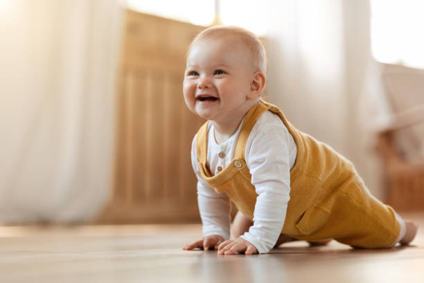 istock Cute little baby boy discovering world, crawling by home 2000889490