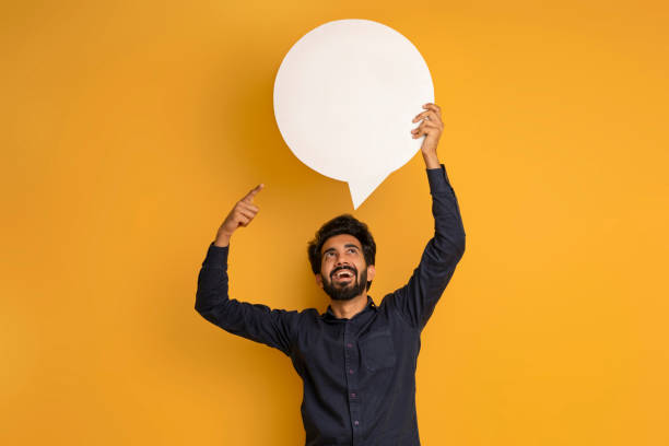 istock Cheerful Excited Indian Man Pointing At Blank Speech Bubble Above His Head 2000901412