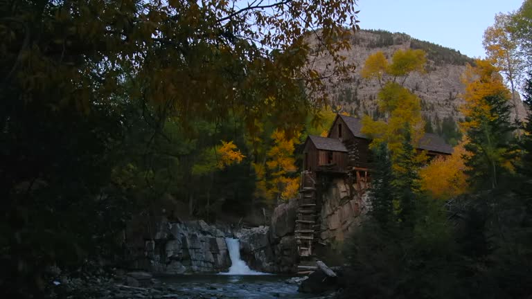Colorado Crystal Mill historic landmark waterfall Crystal River Marble sunset autumn fall aerial drone cinematic golden hour Carbondale Telluride Aspen Pitkin Gunnison county upward slowly motion