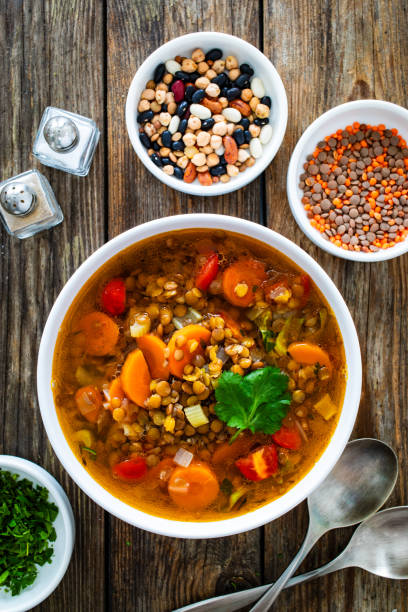 istock Fresh vegetable soup with lentil on wooden table 2000903259