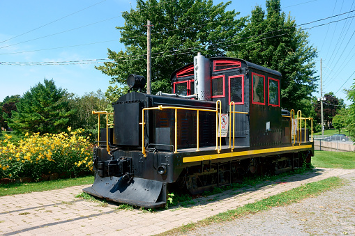 Canada, Gananoque - August 22, 2023: Old diesel locomotive in display at the entrance of the Confederation Park in Gananoque, Ontario