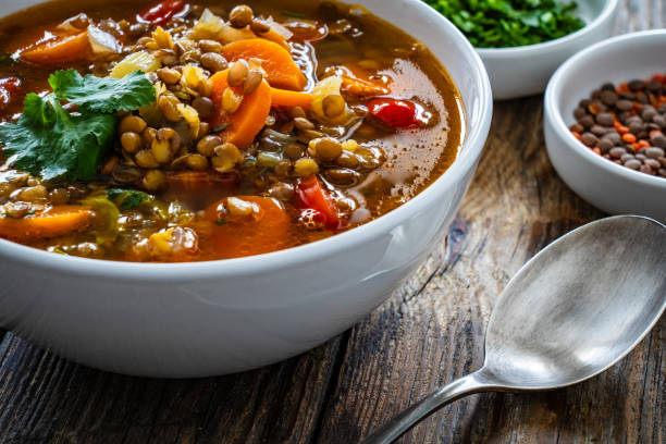 istock Fresh vegetable soup with lentil on wooden table 2000903727