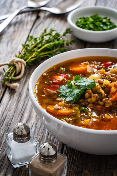 istock Fresh vegetable soup with lentil on wooden table 2000904550