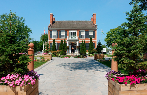 Canada, Gananoque - August 22, 2023: Beautiful landscaped town hall and war memorial monument of  Gananoque, Ontario, on a sunny day