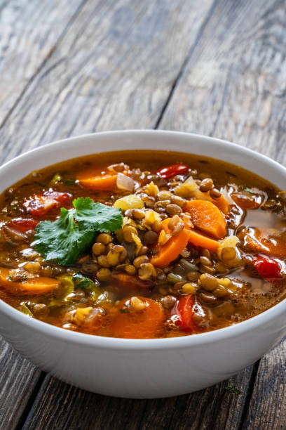 istock Fresh vegetable soup with lentil on wooden table 2000905074