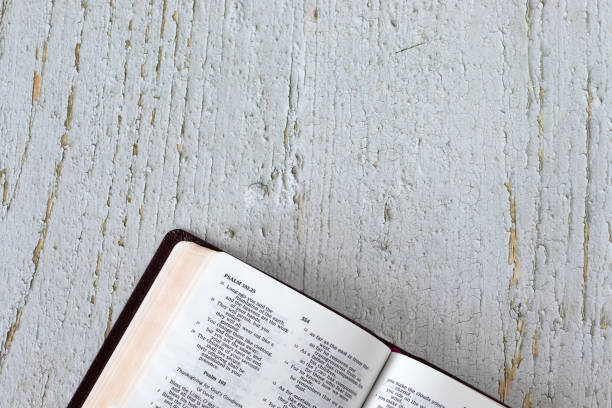 Open holy bible book on wooden background. Top view. Copy space.