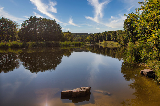 A beautiful place among the fields with a pond in the distance