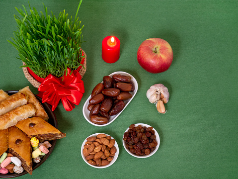 The vernal equinox, a traditional table on Navruz. wheat grass, Arabic baklava dessert, sweets, nuts, dried fruits.