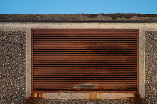 Rusty ventilation grille of an industrial building