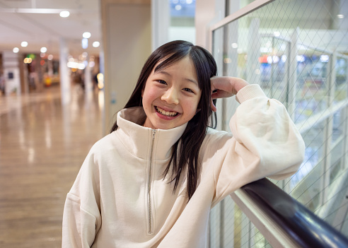 Portrait of happy teenage girl in supermarket