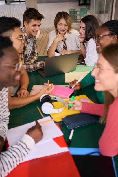 istock Selective focus on a smiling male young university student using laptop in the classroom 2001142516
