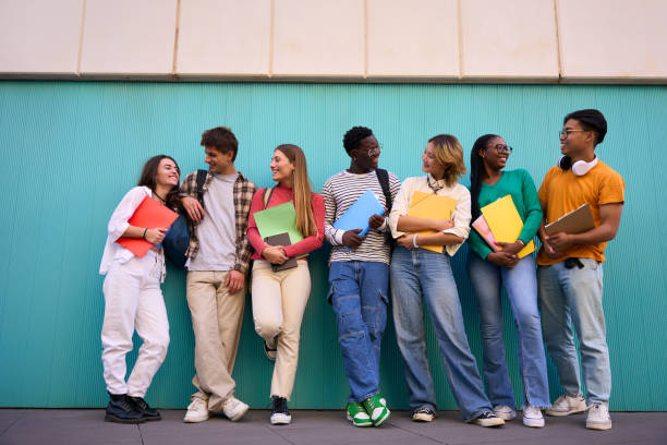 istock Cheerful international students posing standing looking at the camera 2001163710