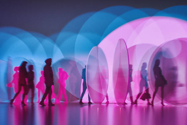 People silhouettes between abstract glass pieces