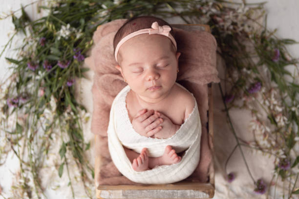 istock Newborn baby girl sleeping in a box. 2001210177