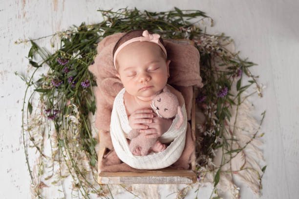 istock Newborn baby girl sleeping in a box. 2001210178