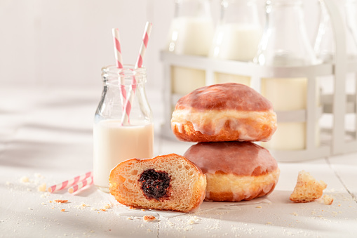 Hot and sweet doughnuts as a popular dessert in Poland. Donuts with jam and sweet topping..