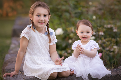 Two little sisters playing in the garden - Buenos Aires - Argentina